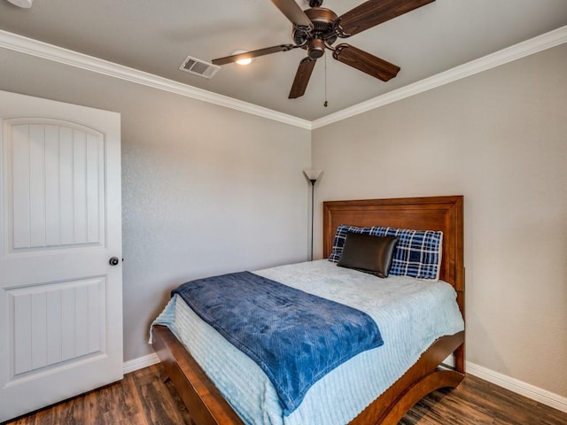 bedroom featuring dark hardwood / wood-style flooring, ceiling fan, and crown molding