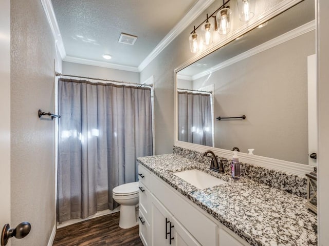 full bathroom with ornamental molding, a textured ceiling, toilet, vanity, and hardwood / wood-style flooring