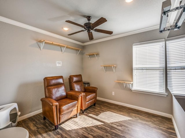 living area with ceiling fan, dark hardwood / wood-style floors, and ornamental molding