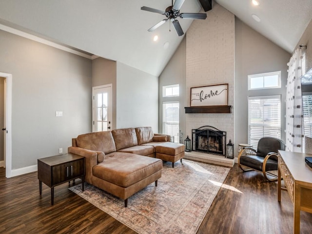 living room with a brick fireplace, dark hardwood / wood-style floors, high vaulted ceiling, and ceiling fan