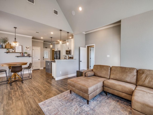 living room featuring ornamental molding, dark wood-type flooring, and high vaulted ceiling