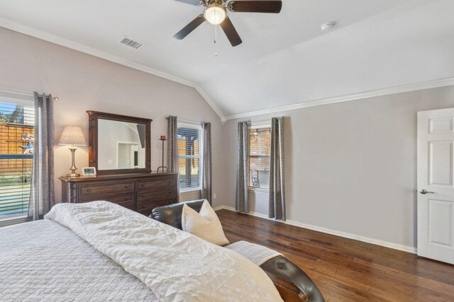 bedroom with ceiling fan, dark hardwood / wood-style floors, crown molding, and vaulted ceiling