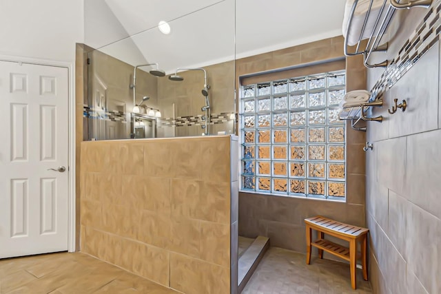 bathroom featuring lofted ceiling and walk in shower