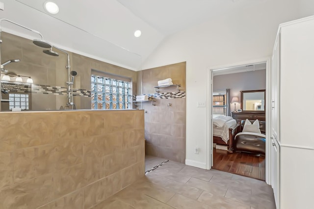 bathroom with tile patterned floors, walk in shower, and vaulted ceiling