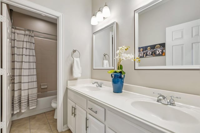 full bathroom with tile patterned floors, shower / bath combination with curtain, toilet, and vanity