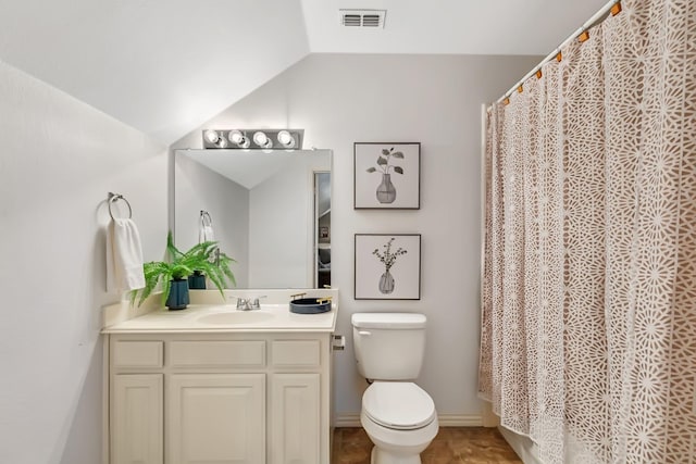 bathroom with vanity, toilet, and lofted ceiling