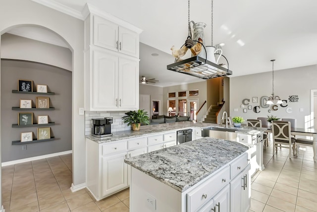 kitchen featuring kitchen peninsula, white cabinetry, ceiling fan, and sink