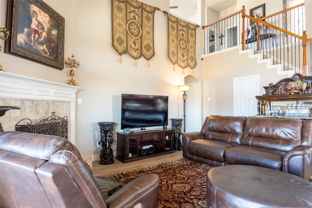 living room with wood-type flooring and a premium fireplace