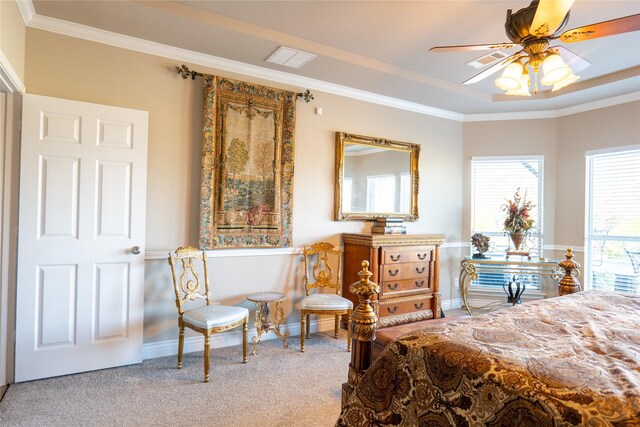 carpeted bedroom featuring a raised ceiling, ceiling fan, and ornamental molding