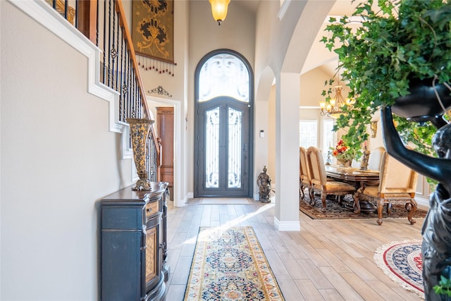 foyer with a notable chandelier and a towering ceiling