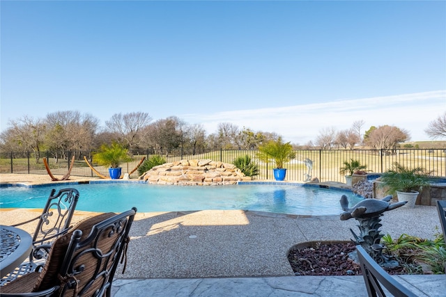 view of swimming pool with a patio area and pool water feature