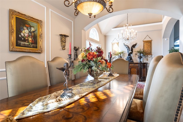 dining room with a chandelier and vaulted ceiling