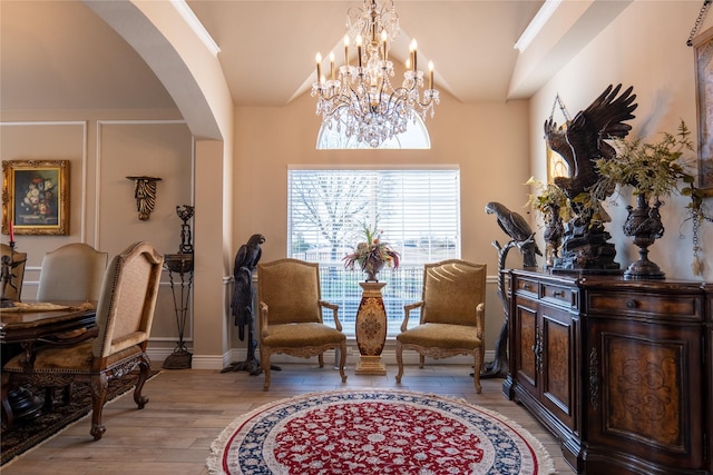 sitting room featuring light wood-type flooring and an inviting chandelier