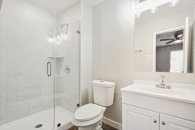 bathroom featuring vanity, ceiling fan, toilet, and walk in shower