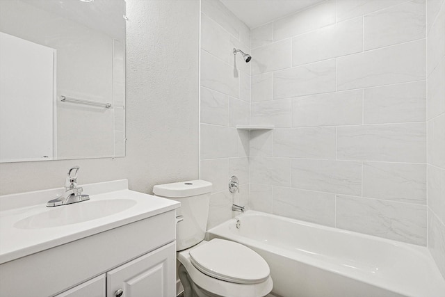 full bathroom featuring tiled shower / bath, vanity, and toilet