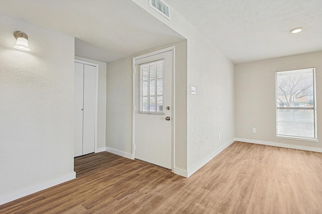 entrance foyer with wood-type flooring and a textured ceiling