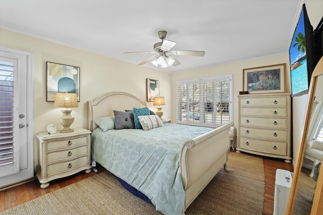 bedroom featuring ceiling fan, dark hardwood / wood-style floors, and ornamental molding