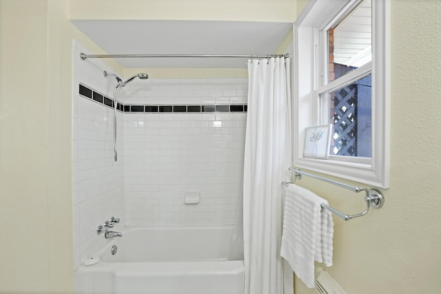 bathroom featuring plenty of natural light and shower / bath combo