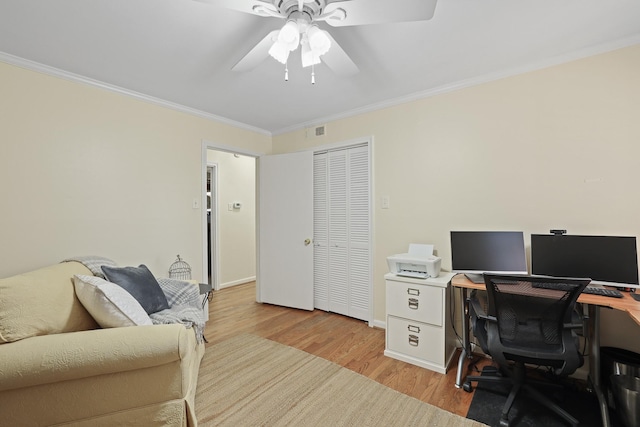 home office with crown molding, light hardwood / wood-style flooring, and ceiling fan