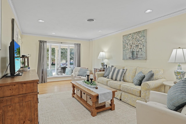 living room featuring crown molding and light wood-type flooring