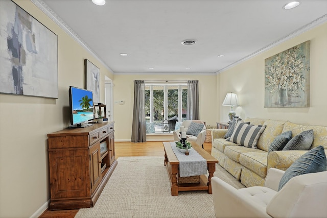 living room with crown molding and light hardwood / wood-style floors