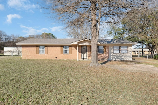 ranch-style home featuring a front yard and a carport