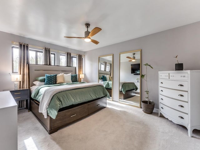 bedroom featuring light carpet and ceiling fan