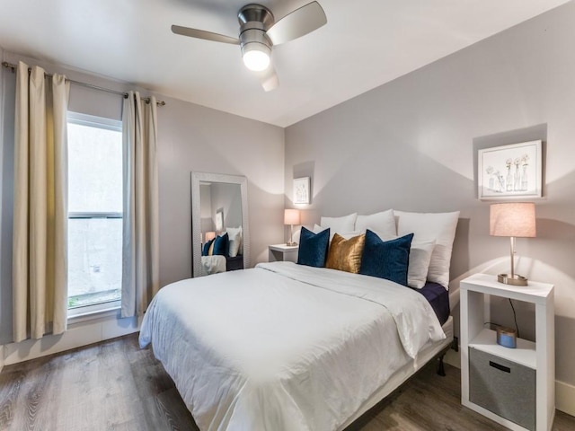 bedroom featuring ceiling fan and dark hardwood / wood-style floors