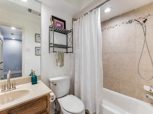 full bathroom featuring vanity, shower / bath combo, and toilet