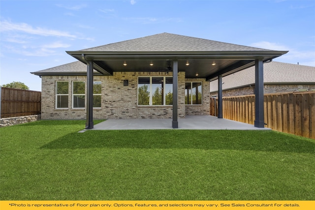 back of house featuring ceiling fan, a patio area, and a lawn