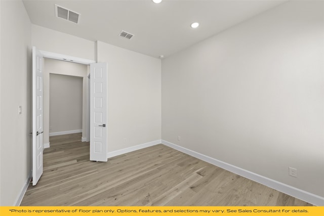 unfurnished room with light hardwood / wood-style floors