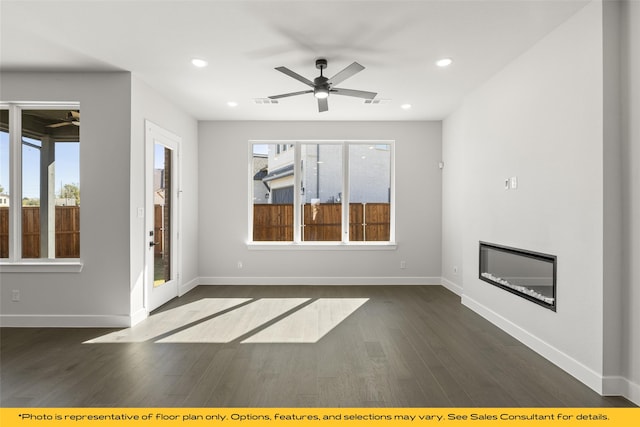 unfurnished living room featuring dark hardwood / wood-style flooring and ceiling fan