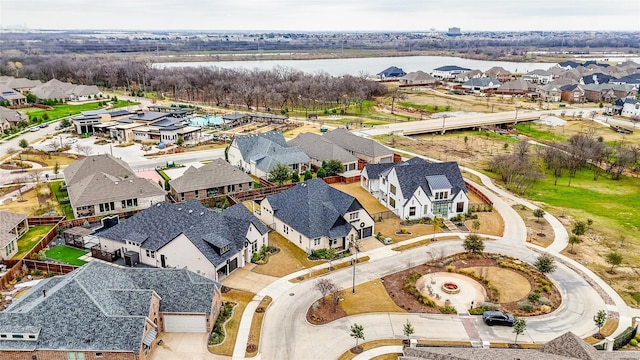 drone / aerial view with a residential view and a water view