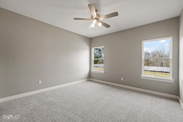 unfurnished room featuring carpet, ceiling fan, and baseboards