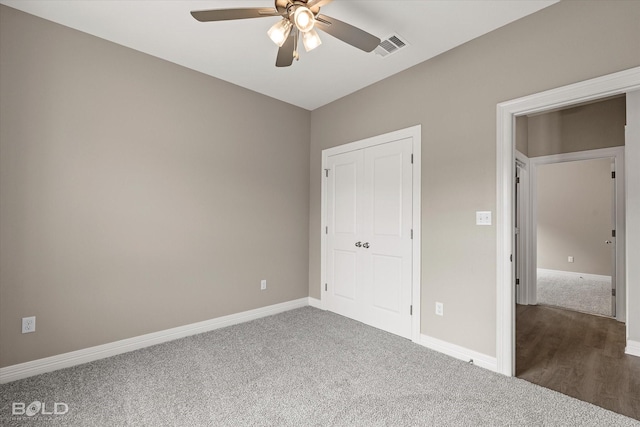 unfurnished bedroom featuring carpet, visible vents, ceiling fan, and baseboards