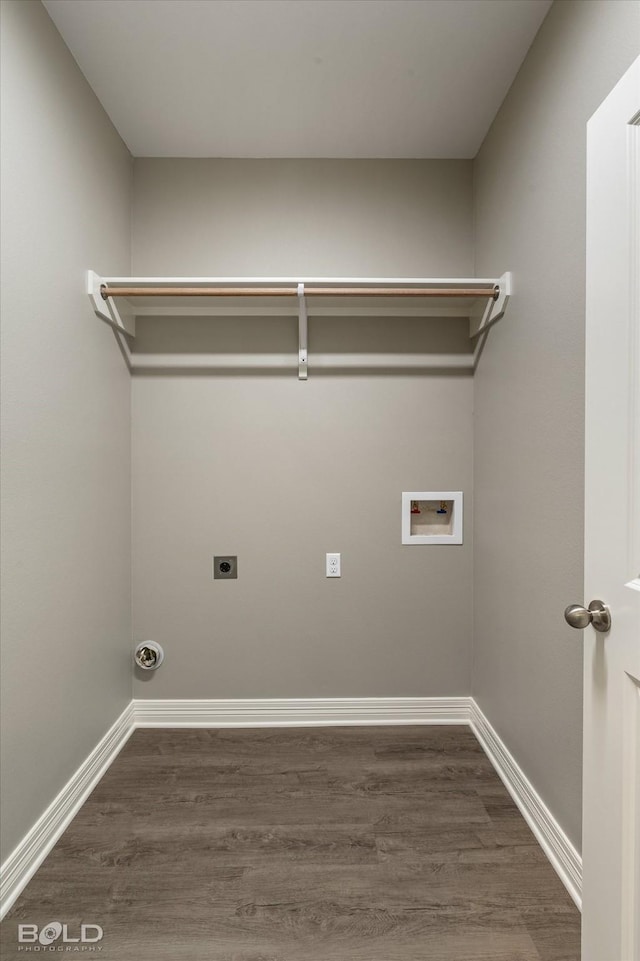 laundry area featuring laundry area, baseboards, dark wood-type flooring, hookup for an electric dryer, and washer hookup