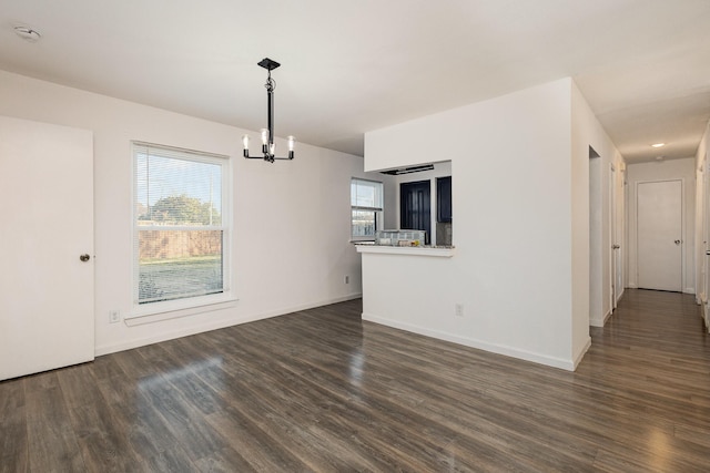 interior space featuring an inviting chandelier and dark hardwood / wood-style flooring