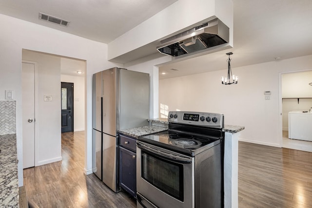 kitchen featuring washer / dryer, stainless steel appliances, a notable chandelier, hanging light fixtures, and light stone countertops