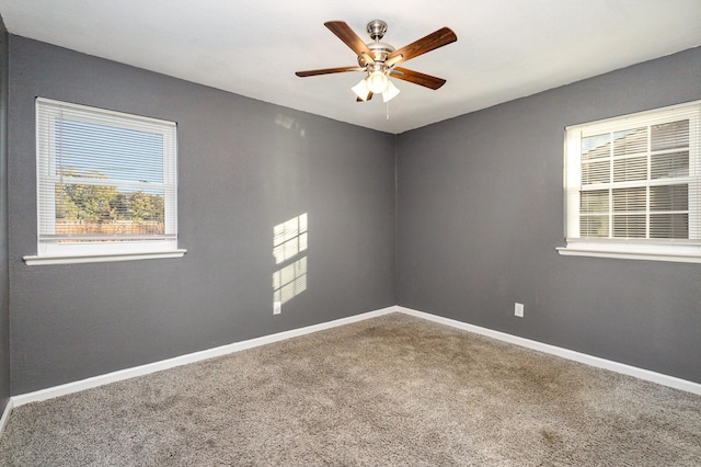 empty room featuring ceiling fan and carpet