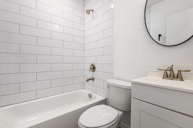 full bathroom featuring tiled shower / bath combo, vanity, and toilet