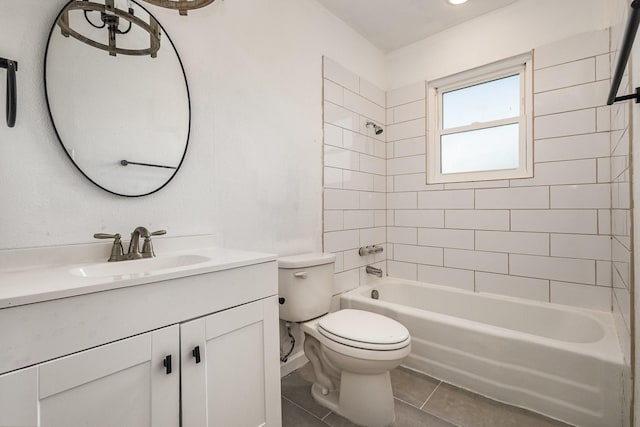 full bathroom with toilet, tiled shower / bath, vanity, and tile patterned floors