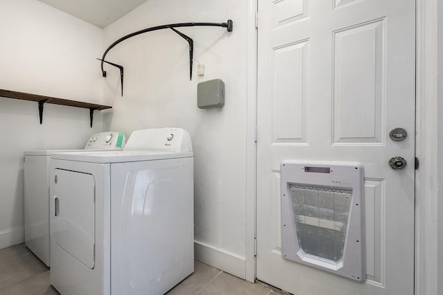 clothes washing area featuring light tile patterned floors and independent washer and dryer