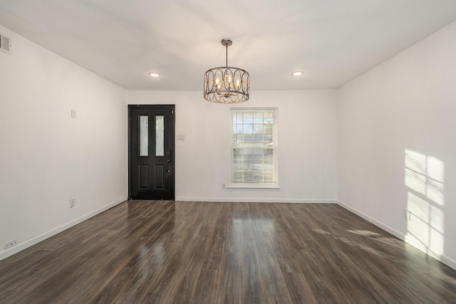 interior space with dark hardwood / wood-style flooring and an inviting chandelier