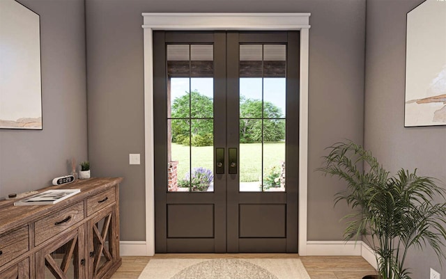 doorway with light hardwood / wood-style floors and french doors