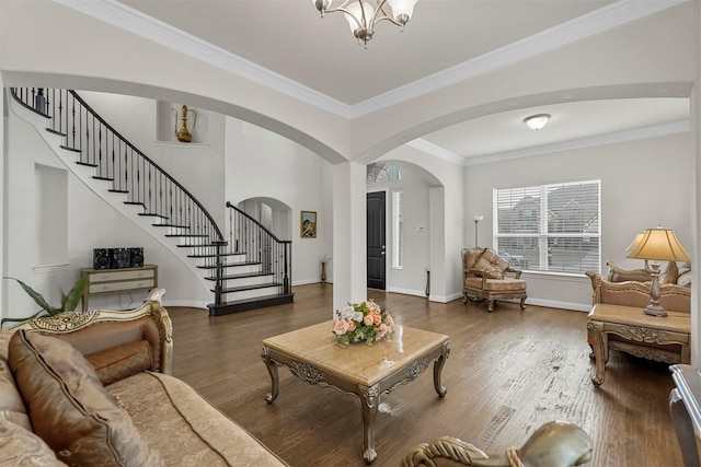 living room with a notable chandelier, dark hardwood / wood-style floors, and crown molding