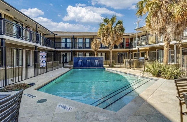 view of swimming pool with pool water feature