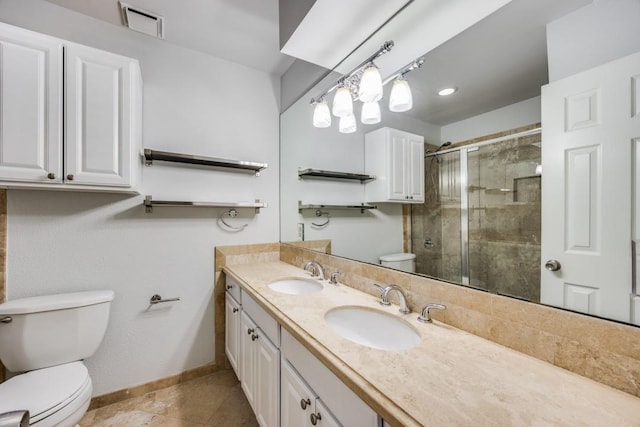 bathroom with tile patterned flooring, vanity, toilet, and a shower with shower door