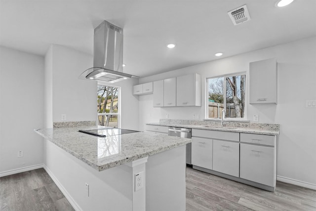 kitchen with sink, stainless steel dishwasher, island exhaust hood, kitchen peninsula, and black electric cooktop