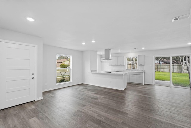 unfurnished living room featuring dark hardwood / wood-style flooring and sink