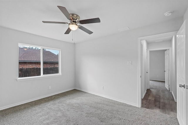 carpeted spare room featuring ceiling fan